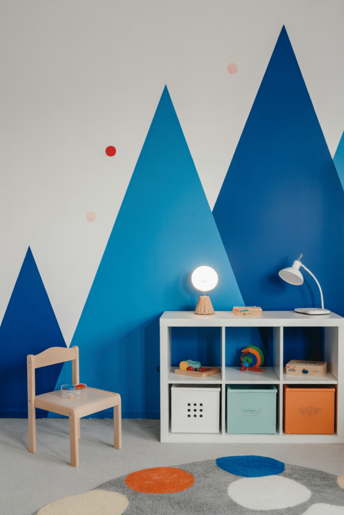 Blue geometric accent wall brings playful, modern energy to a creative space.