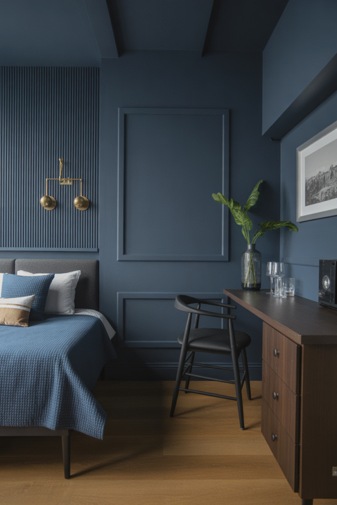 Matte navy accent wall sets a dramatic, cozy mood in a stylish bedroom or lounge space.