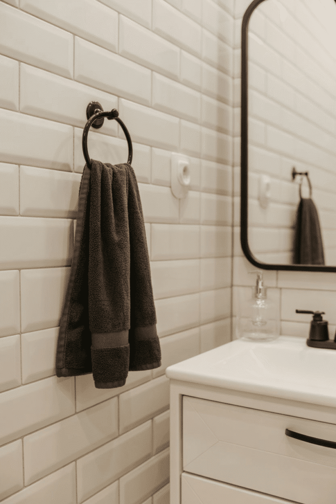 Black towels provide contrast in a white bathroom design.

