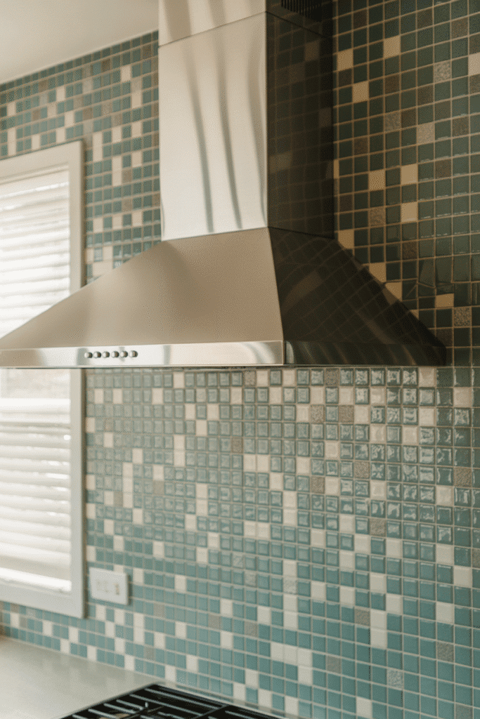 Mixed tile backsplash adds texture and visual interest to a modern kitchen.