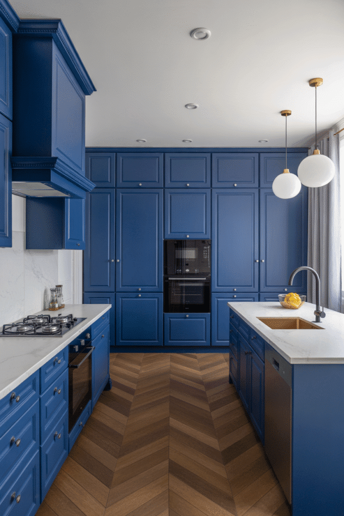 Bold cobalt blue cabinetry makes a dramatic statement in a sleek kitchen.