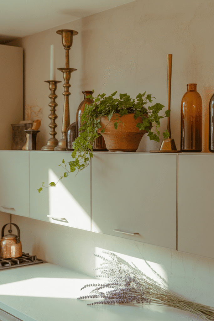 Mixing heights in decor adds depth and visual interest above cabinets.

