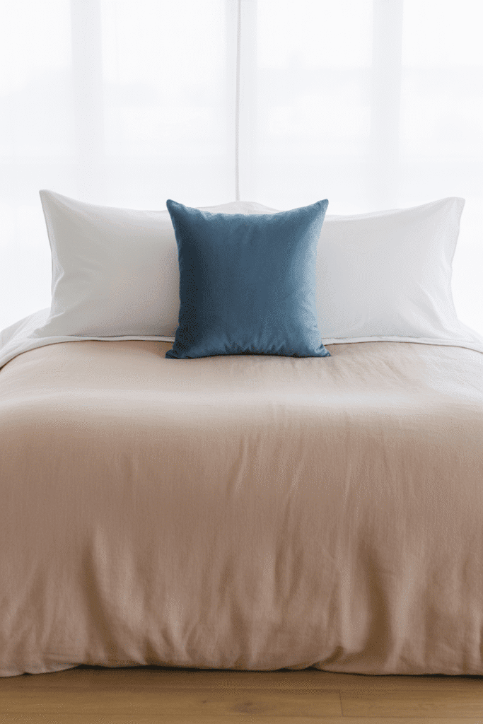 One bold statement pillow adds drama to a clean, minimal bed.