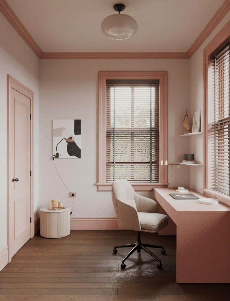 Home office with soft pink paint on window and door trim, adding subtle elegance against white walls.