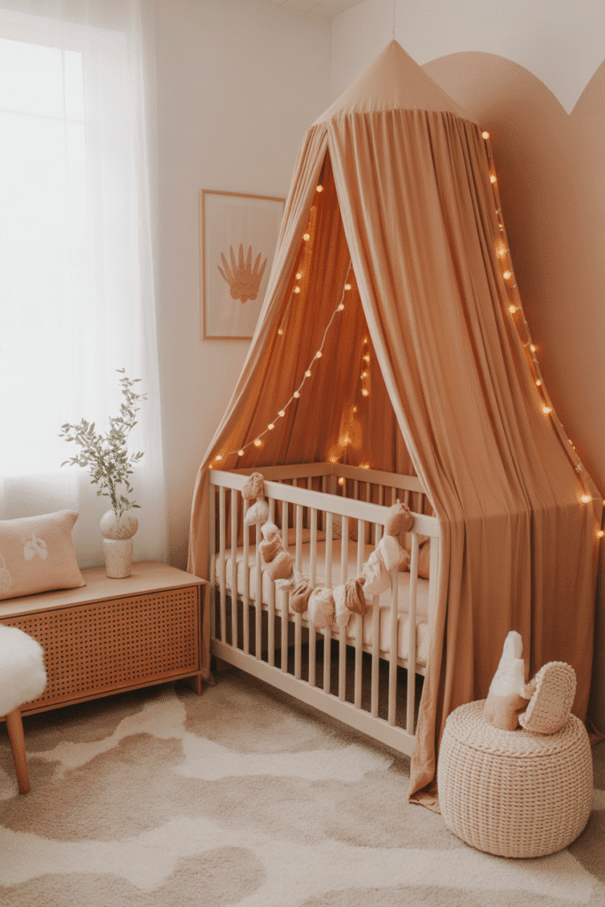 Girly nursery with blush canopy and fairy lights.