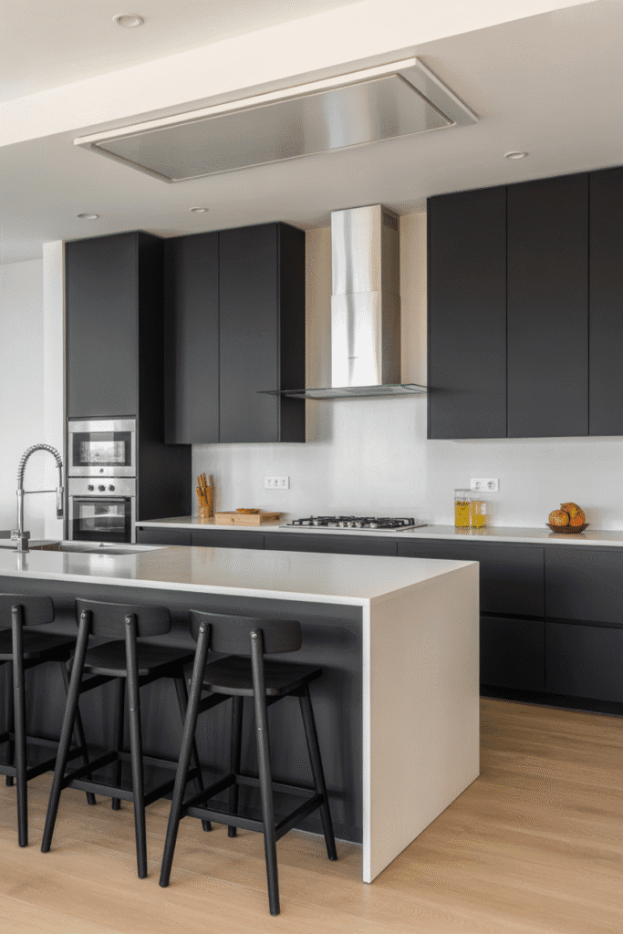 As a part of Dark Kitchen Cabinet Ideas this picture shows matte black kitchen cabinets paired with white surfaces create a sleek, modern look.