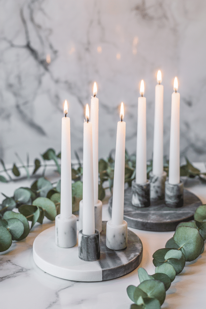 Modern fall centerpiece with candles on marble coasters.
