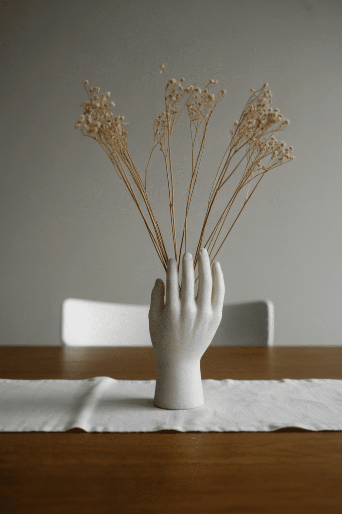 Minimalist fall table with statement vase on white runner.