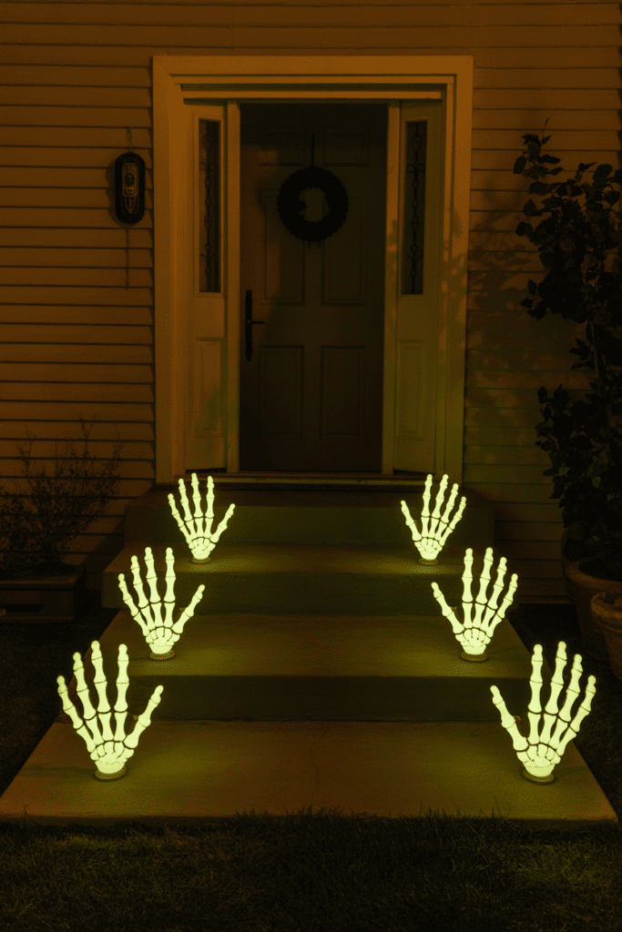 Halloween pathway lights glowing in the dark, illuminating the porch walkway for a spooky entrance