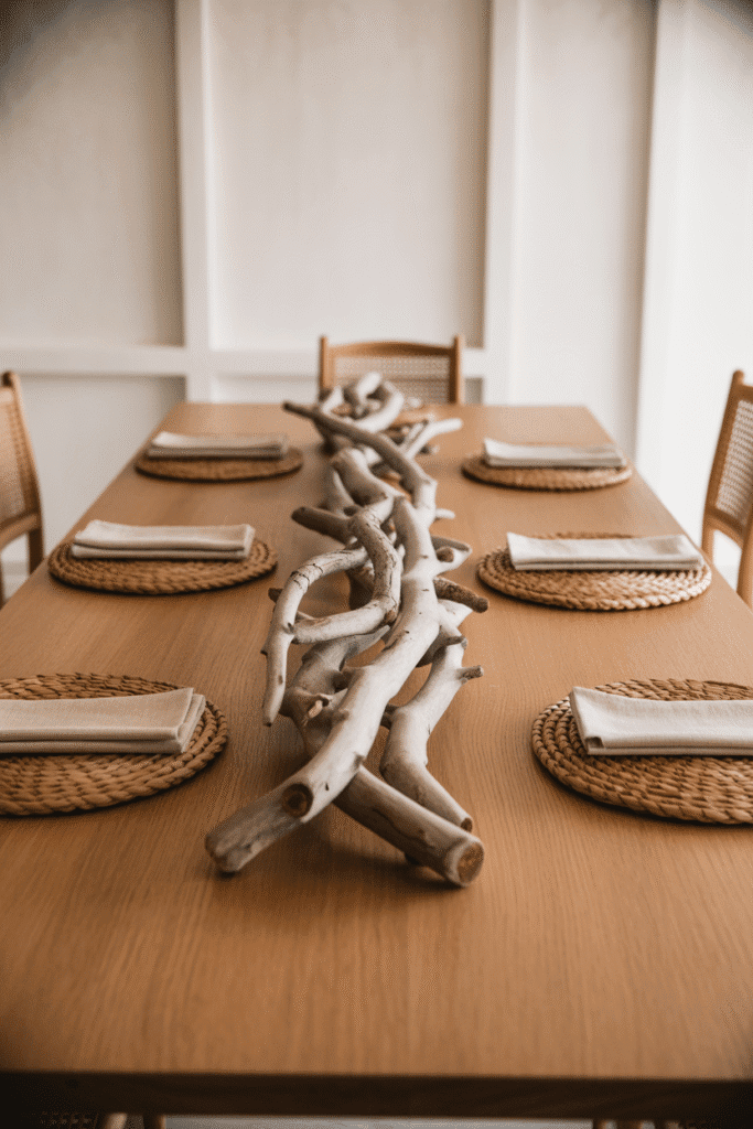 Dining table with ceramic vase centerpiece filled with pampas grass in organic modern style.