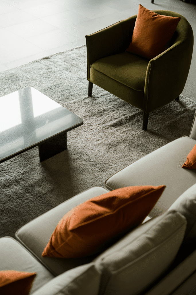 Mid-century living room with neutral walls and bold accents in olive green and burnt orange.