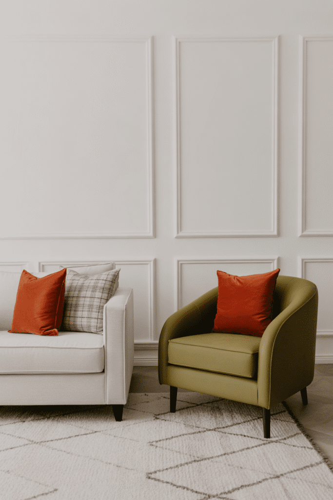 Mid-century living room with neutral walls and bold accents in olive green and burnt orange.